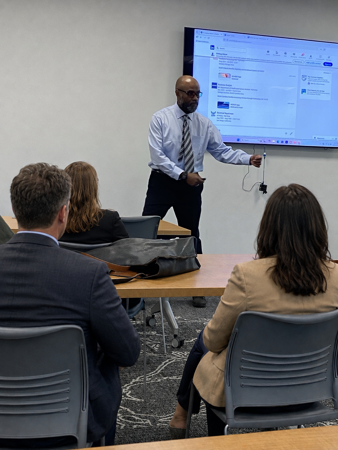 Lindsay Alston presenting to an audience during an analytical reasoning workshop